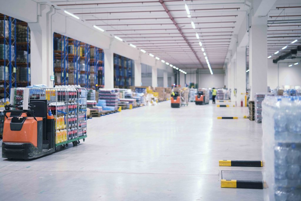 Warehouse industrial building interior with people and forklifts